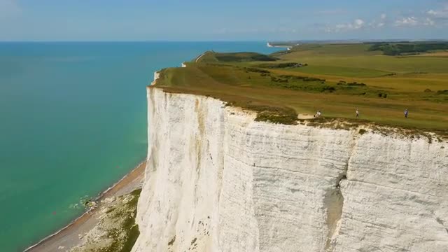 High aerial drone footage of walkers on the white cliffs, Seven Sisters 