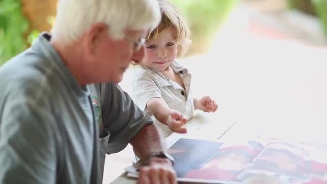 Caucasian grandfather and grandson drinking iced tea