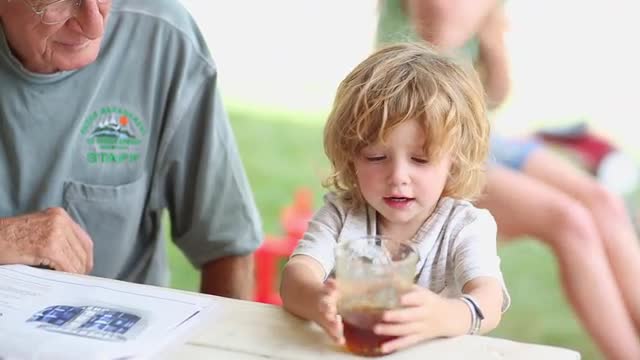 Caucasian grandfather and grandson drinking iced tea