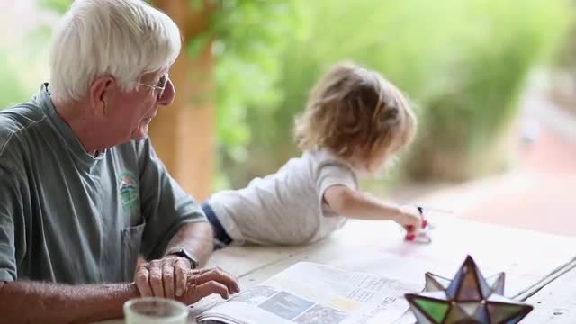 Caucasian grandfather and grandson playing at table