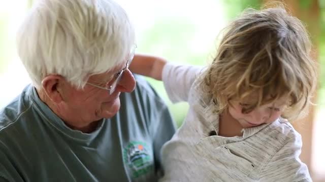 Caucasian grandfather holding grandson