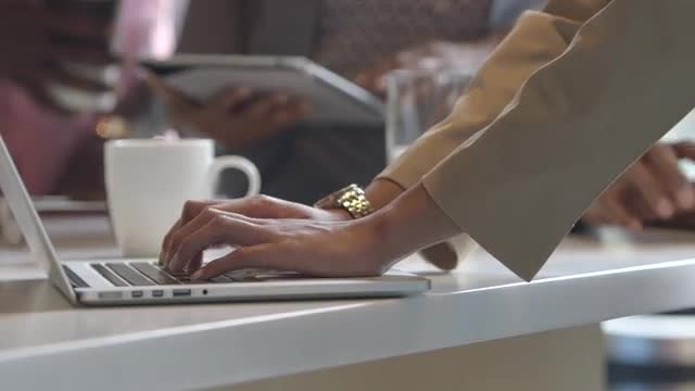 Businesswoman using laptop in office