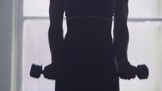 Black athlete lifting weights