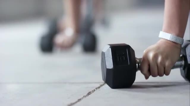Athletes doing dumbbell exercises