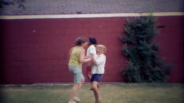 1969: Multicultural kids playing backyard dodgeball.