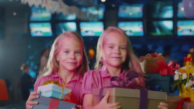 Two Girls with Gifts at Children Birthday Party. Shot on RED Cinema Camera in 4K (UHD).