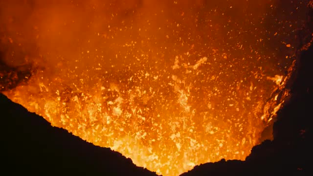 Volcano erupting lava at night 2