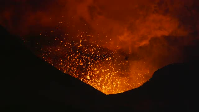 Volcano erupting lava at night 3