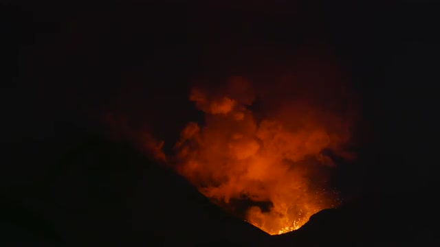 Volcano erupting lava at night 4