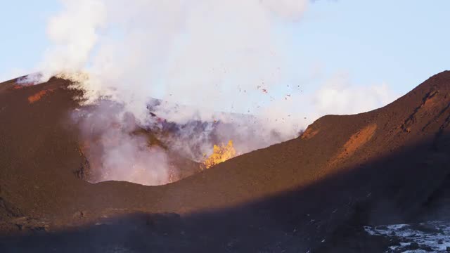 Lava erupting from volcano during the day 3