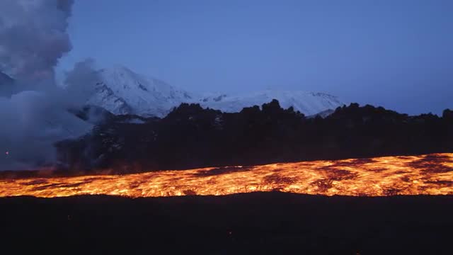 Camera pans to show river of lava