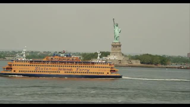 2 Staten Island Ferries pass with Liberty Island in back