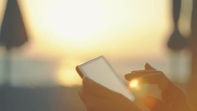 Woman Working With Tablet At Sunset