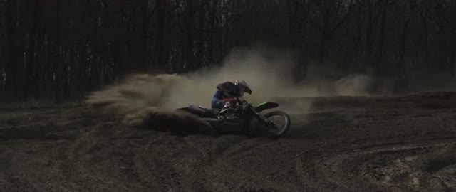 Motocross racer going through corner and crashin