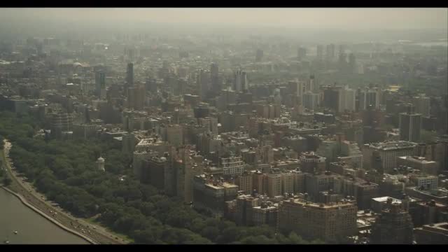 Pan up water to Uptown buildings along east side 