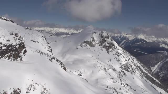 Drone Flies by mountain range - Fresh Powder Scoping