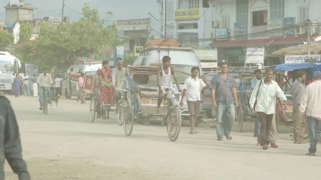 Busy Street with Motorcycles and Rickshaws