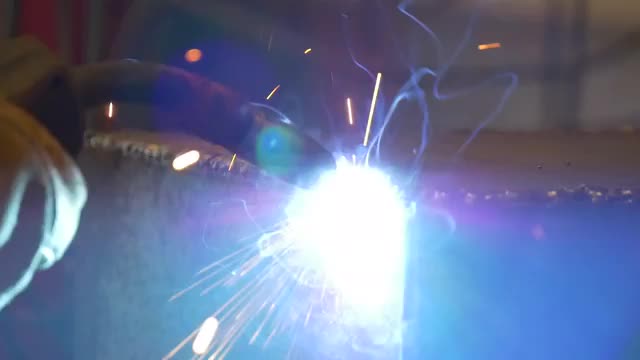 Welding metal welding machine. Spatter, work gloves melt metal iron construction
