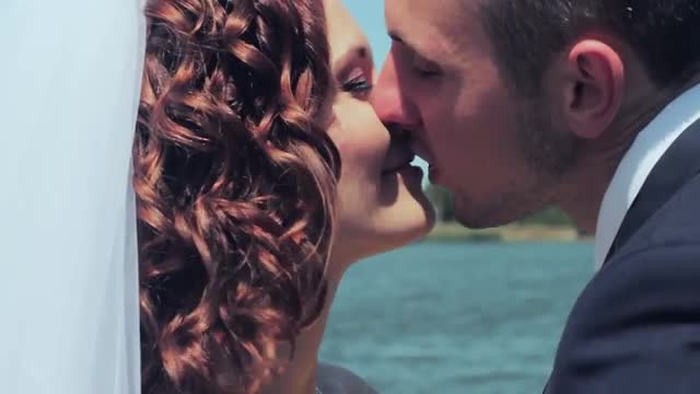 Newlyweds Kissing on The Background of The Lake. Wedding.