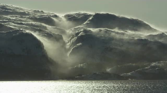 Wind blowing snow across mountain top