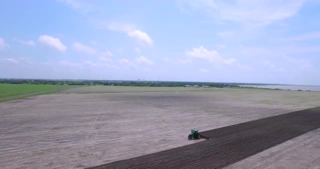 Aerial of tractor plowing farm