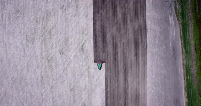 Static Overhead of tractor plowing farm field