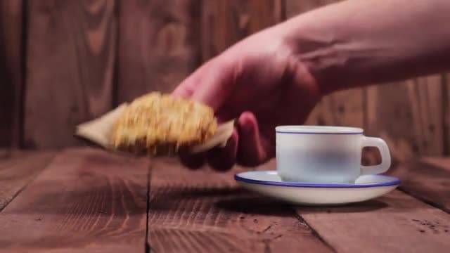 the Waiter Puts the Coffee and Cookies on the Table.