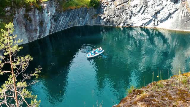 People on Boat Swimming at Marble Canyon Ruskeala