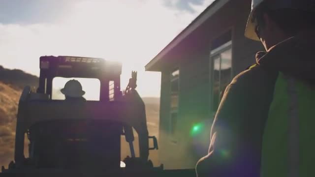 Construction worker signaling to machine operator