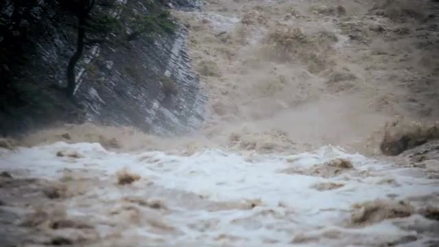 Fast flowing flooded river after rain storm, USA