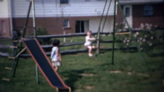 1963: Boy swings dangerously high on see saw type playground.