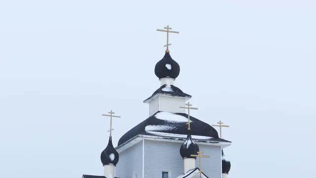 Domes of Orthodox Church in Kondopoga, Russia During Snowfall