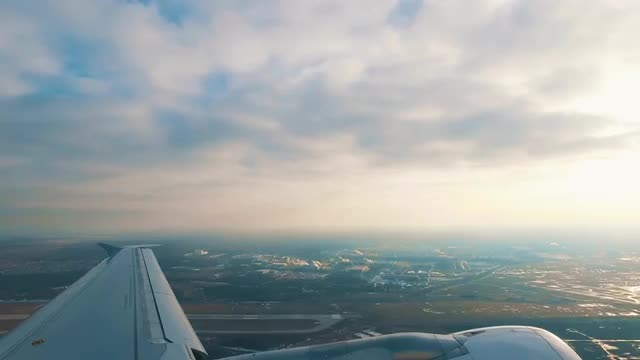 Airplane is Takeoff Above the City, view from the porthole