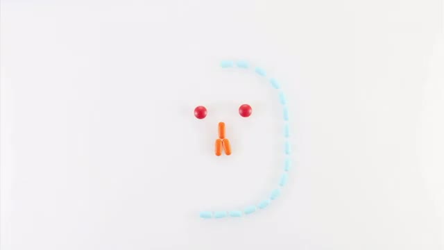 Tablets forming smiley face on white background