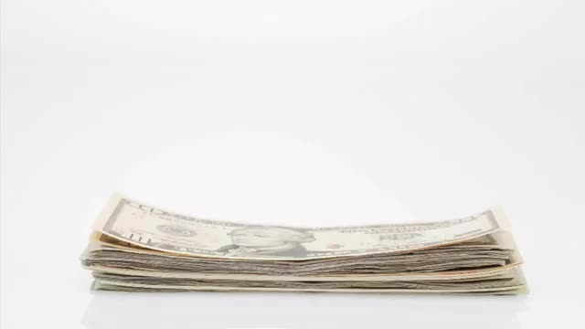 Pile of US dollars on white background