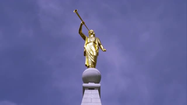 Tight shot of the gold statue Moroni atop the LDS Salt Lake Temple.
