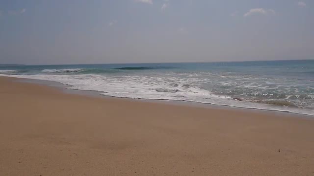 Ocean seascape scenic of tangalle beach, Sri lanka with wave crashing on sandy shore.