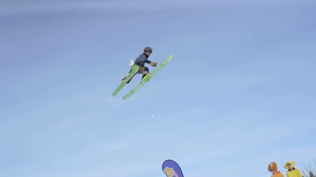 Skier flies through air during big air contest doing a 360