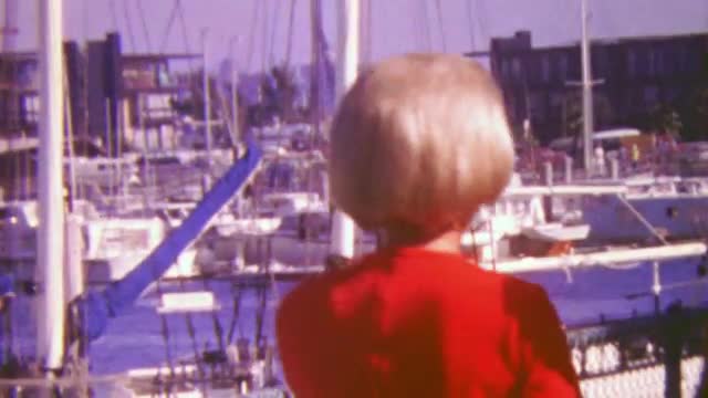1964: Buyers inspecting boat harbor property rentals for sale.