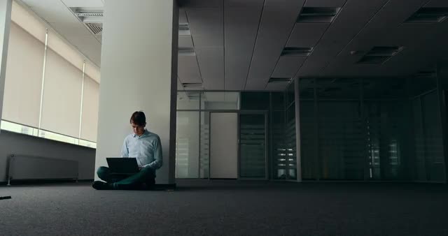 Young man working alone in empty office