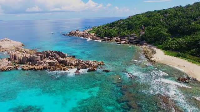 Aerial view (landscape) of tropical paradise beach (coast) with white sand and azure sea water