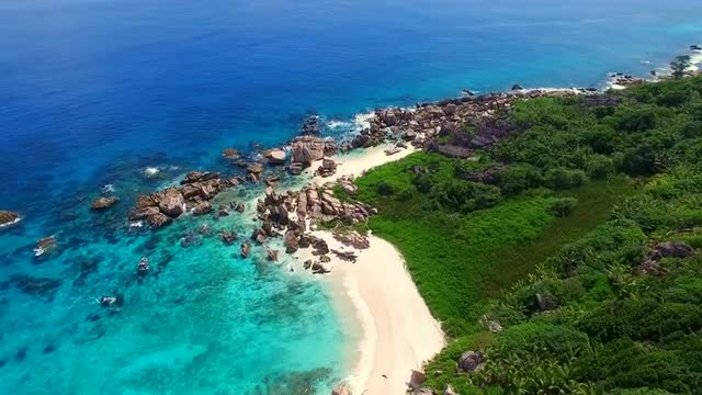 Aerial view (landscape) of empty tropical paradise beach (coast) with white sand and azure sea water