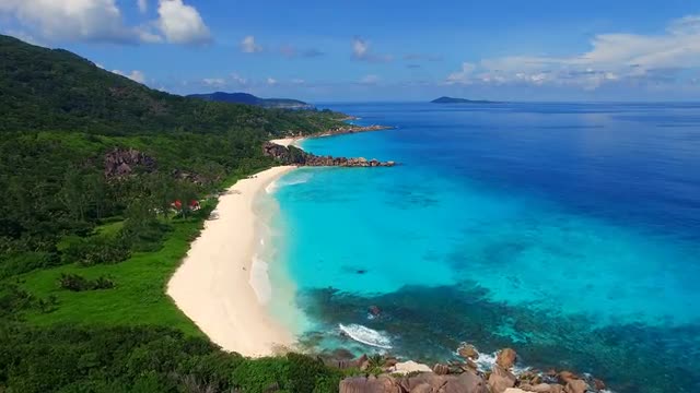 Aerial view of tropical paradise beach with white sand and turquoise sea water of Indian Ocean