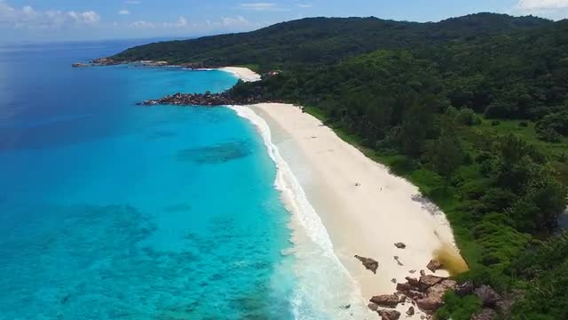 Aerial view of tropical paradise beach with white sand and turquoise water - Seychelles