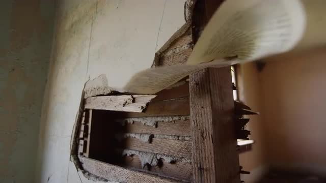 Movi shot of paper stuck on wood doorway
