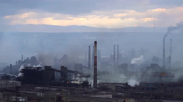 Air Pollution From Industrial Plants. Large Plant on the Background of the City. Pipes Throwing Smok