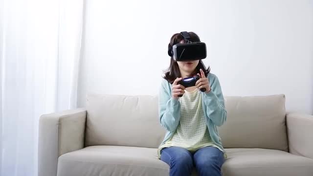 Japanese young woman using virtual reality device