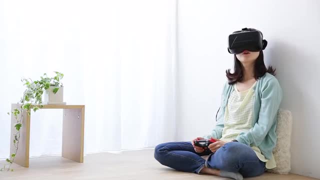 Japanese young woman using virtual reality device