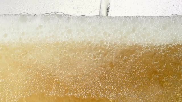 Pouring ginger ale in a glass
