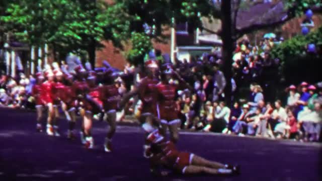 1952: Marching band chorus line parade woman falls after high kick.